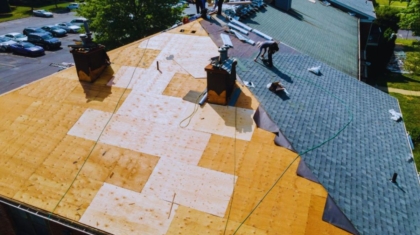 Contractors working on a commercial roof during a repair or replacement project.