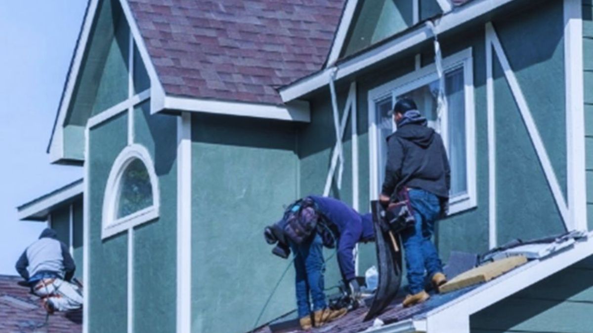 Roofers inspecting and repairing asphalt shingles during roof maintenance in Ridgeland.