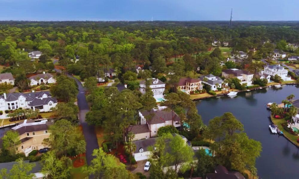 Aerial view of luxury waterfront homes and tree-lined streets in Wexford Plantation, Hilton Head Island, SC.