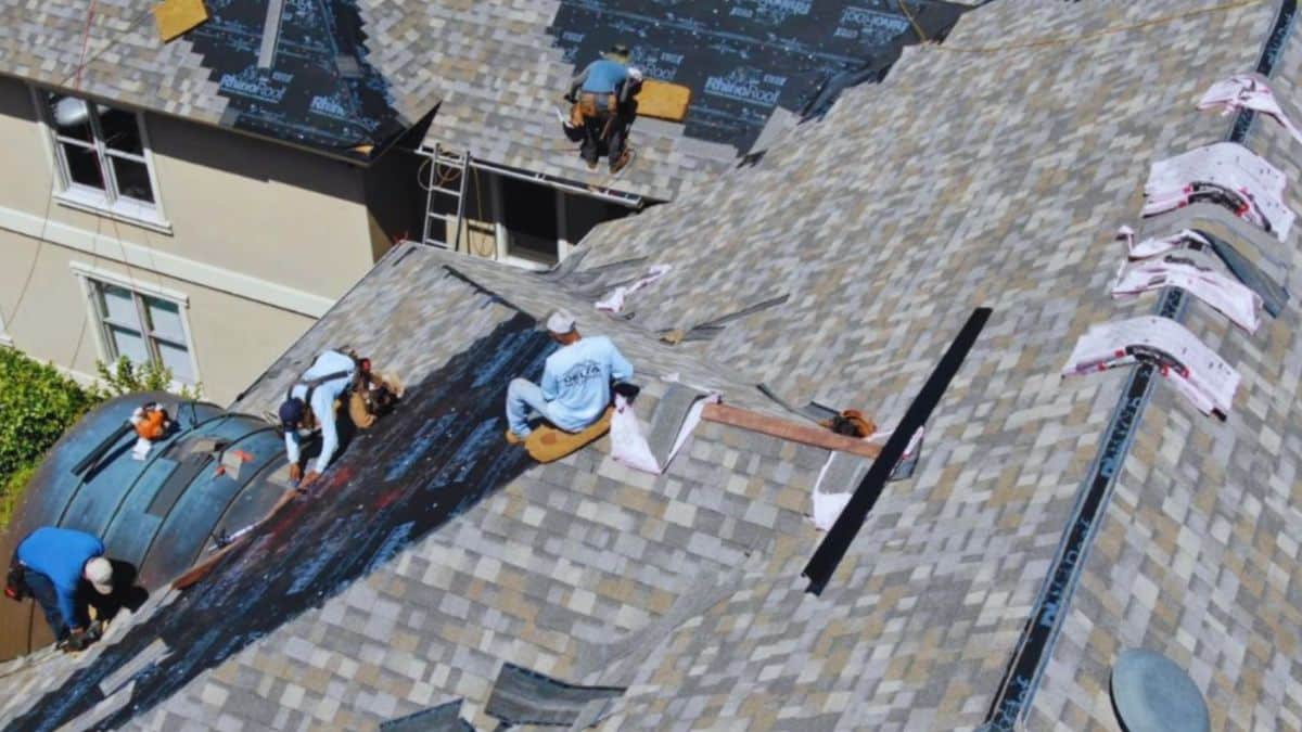 Roofing contractor in Bluffton installing shingles and roof underlayment on a residential home during a professional roof replacement project.