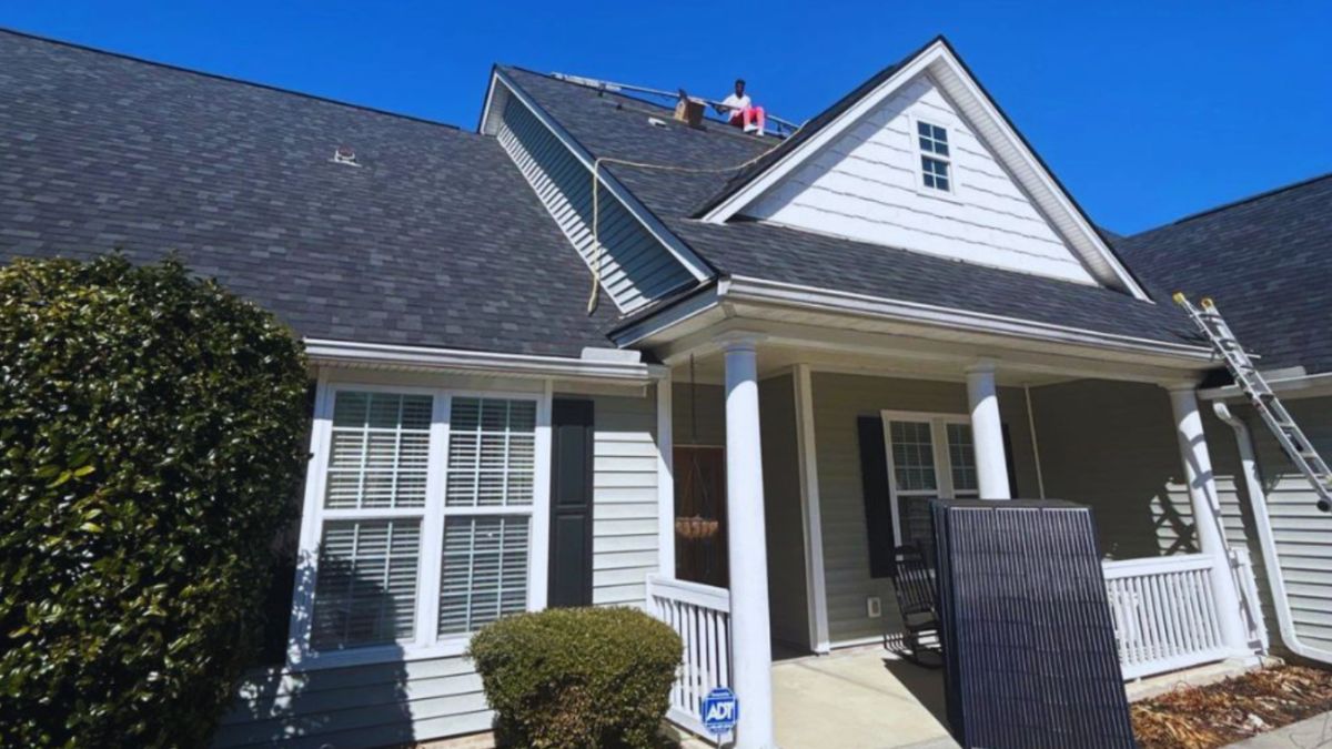Roofing contractors performing roof installation on a large residential home with architectural shingles, showcasing professional roofing services in Devil's Elbow Barony Plantation (Okeetee Barony).