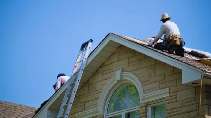 Roofers performing an emergency roof repair on a residential home in Hilton Head, SC.