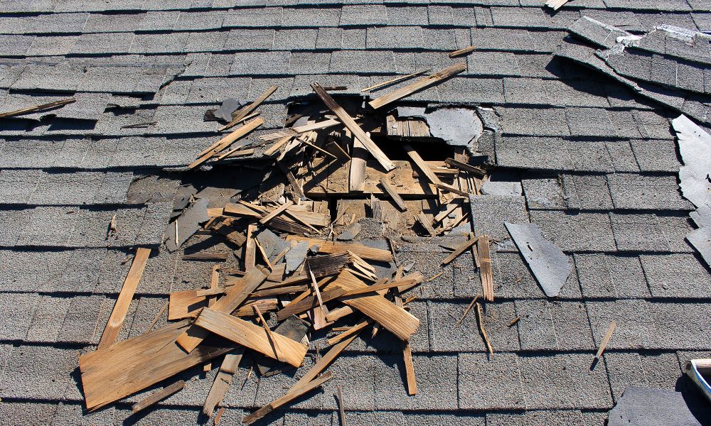 Close-up of aged roof shingles curling and cracking under sunlight on a Bluffton, SC home